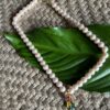Pearl Neckpiece With A Happy Pendant